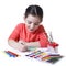 Child drawing with pensil using a lot of painting tools