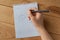 A child is drawing smiley face on the blank squared paper