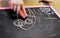 Child draws chalk on a blackboard