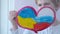 The child dreams of peace and friendship. friendship concept. The child draws the flags of Russia and Ukraine on the