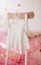 Child dress on hanger on pink background