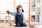 Child dressed like pilot aviator plays with a toy airplanes at home in his room