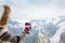 Child drinking tea in thermos in mountains