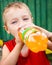 Child drinking unhealthy bottled soda