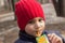 The child drinks juice in the Playground. emotional close-up portrait.