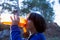 A child drinks water from a refillable bottle