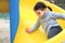 the child drives off a steep slide on the playground