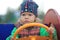 Child drives wooden car on the kindergarden playground