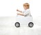 Child driving toy box car.