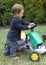Child driving toy tractor