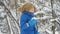 Child eat fresh snow lying in his hands. Little boy having fun playing with fresh snow.