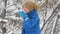 Child eat fresh snow lying in his hands. Little boy having fun playing with fresh snow. Active outdoors leisure for child in snowy