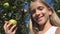 Child Eating Apple, Kid in Orchard, Farmer Girl Studying Fruits in Tree