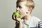 Child eating apple.Little Boy with green apple. Health food. Fruits