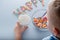 The child eating a breakfast cereal. word with grain loops happy on a blue background.top view