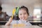 Child eating an fruit, lots of fresh fruit on the table in front as after school