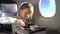 Child eating healthy lunch in airplane.