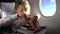 Child eating healthy lunch in airplane.