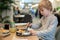 Child, eating japanese sushi and noodles with chopsticks in a restaurant