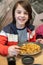 Child, eating japanese sushi and noodles with chopsticks in a restaurant