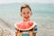 Child eating juicy watermelon. Kids emotions boy eating watermelon on the background of the sea, the beach, the sea coast