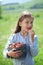 Child eating strawberries in a field