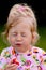 Child eating a strawberry in the garden