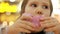 Child eats donut. Closeup baby girl eating doughnut with glase. Delicious, sweet, sweettooth.