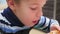 Child eats fried chicken in a fast food restaurant closeup