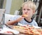 Child eats pizza.