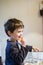 Child eats pizza sitting at the kitchen table