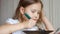 Child eats soup with a spoon. Closeup baby girl sitting at the table of home cooking and eating food