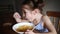 Child eats soup with spoon from plate at home