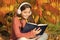 Child enjoy reading. Studying twice faster using visual and audio information. Girl read book on autumn day. Little