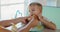 Child Enjoying a Hamburger at a Bright Cafe