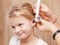 Child ENT check - doctor examining ear of a little girl with otoscope