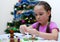 The child enthusiastically assembles a constructor presented for the holiday. Blurry, defocused, selective focus. Copy space