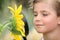 Child examining a sunflower