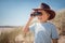 Child explorer with binoculars at the beach