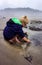 Child explores tide pool vertical layout
