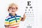 Child at eye sight test. Kid at optitian. Eyewear for kids.