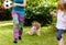 Child falling down running, playing ball with family in the garden, injury concept. Kids outdoors sport activity accident, fall