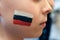 Child fan of the Russian national team. Boy with image of the flag of Russia on the cheek.