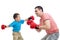 Child and father play with boxing gloves