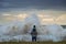 Child on the fathers shoulders standing against the stormy sea