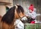 Child feeding a horse in winter