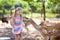 Child feeding wild deer at zoo. Kids feed animals