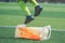 Child feet with football boot practicing Jumping over the cone on soccer field, For children Soccer academy training concept