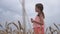 child in a field with yellow wheat