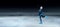 Child  figure skater on dark ice arena background